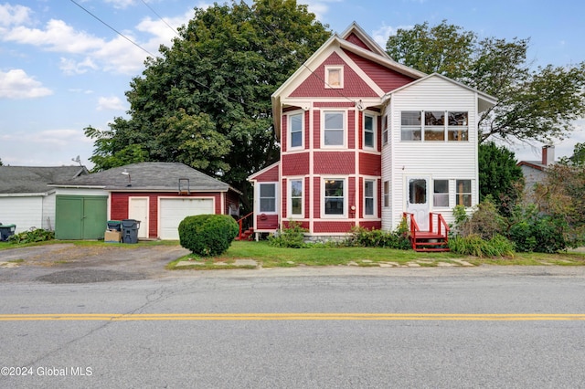 view of front of home with a garage and an outdoor structure