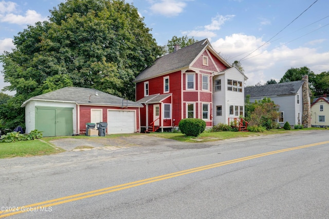 view of front of property with an outdoor structure and a garage