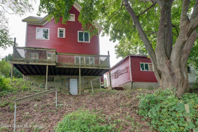 back of property featuring a wooden deck