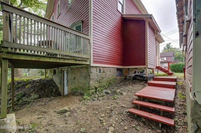 view of side of property featuring a wooden deck