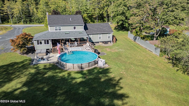 exterior space featuring a lawn and a fenced in pool