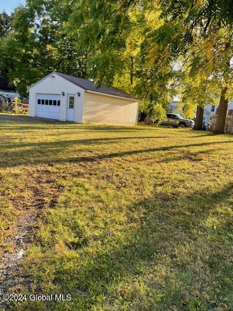 view of yard with an outbuilding and a garage