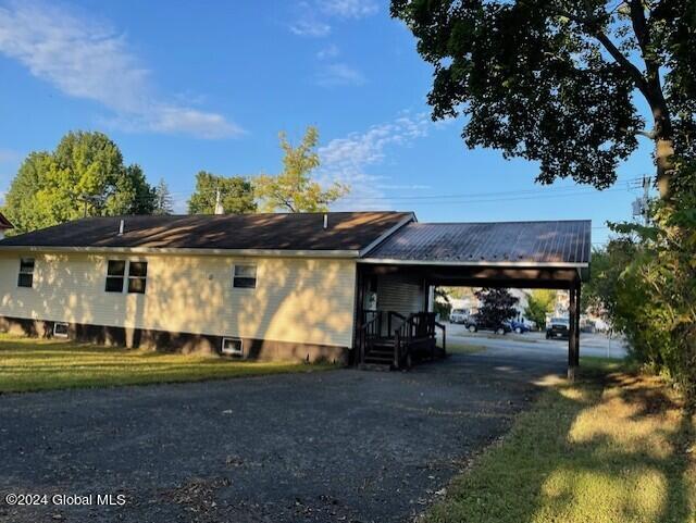 view of property exterior featuring a carport