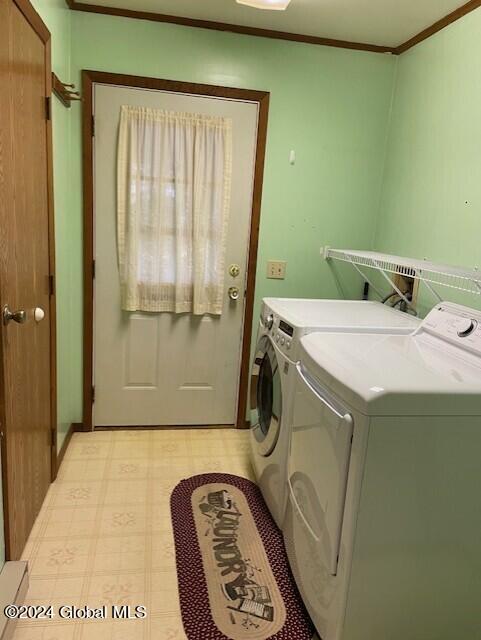 washroom with independent washer and dryer and ornamental molding