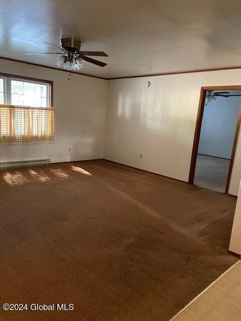 carpeted spare room featuring a baseboard radiator and ceiling fan