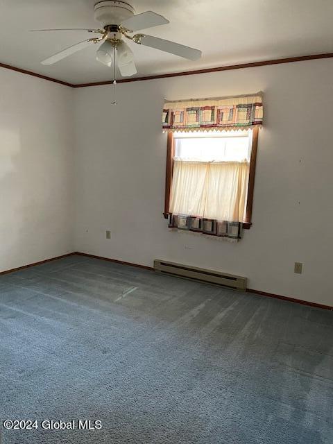 carpeted spare room with ceiling fan, a baseboard radiator, and crown molding