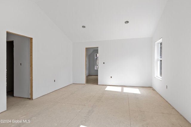 empty room with lofted ceiling