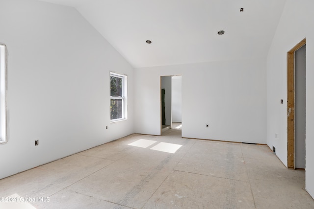 unfurnished room featuring lofted ceiling