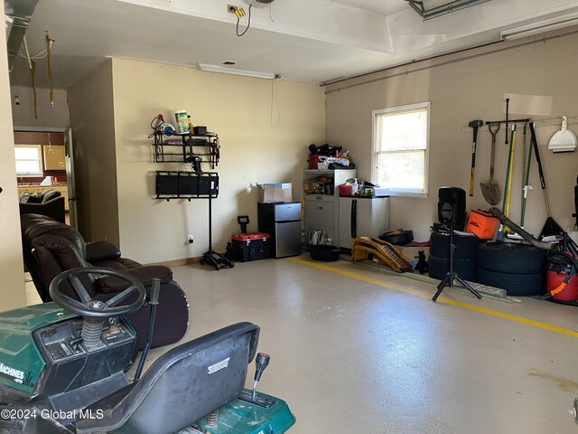 garage with stainless steel refrigerator