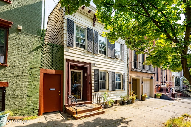 view of front of house featuring cooling unit and a garage