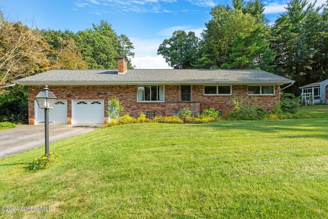 single story home with a garage and a front yard