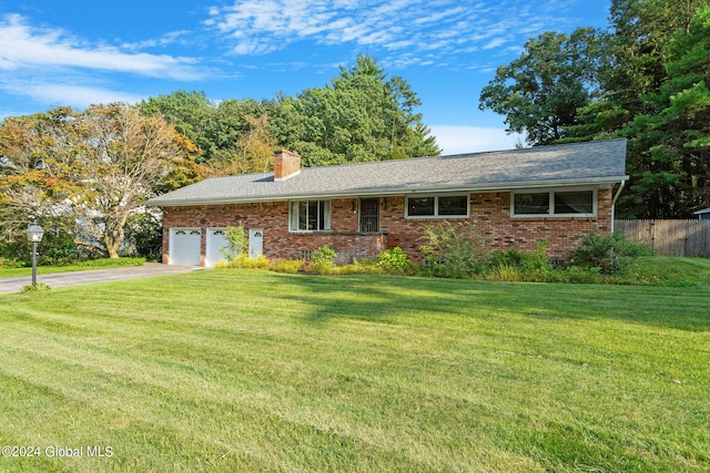 ranch-style house featuring a front yard and a garage