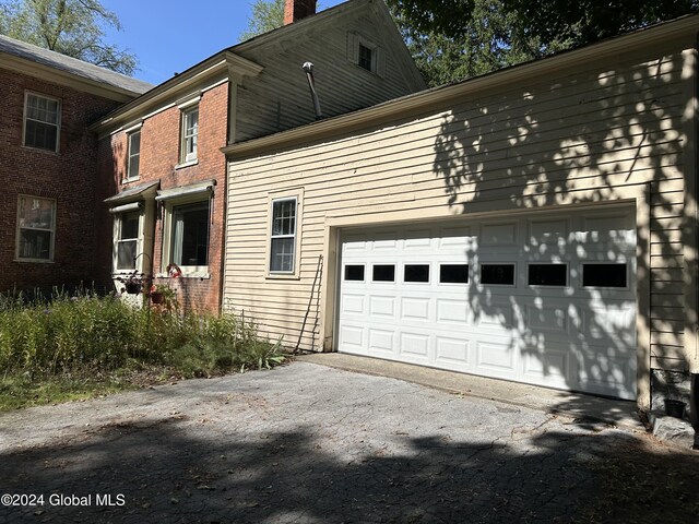 view of side of home featuring a garage