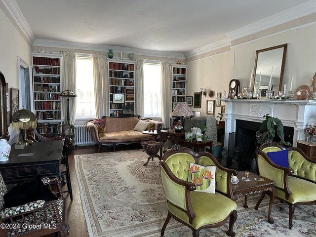 living room featuring radiator heating unit, ornamental molding, and wood-type flooring