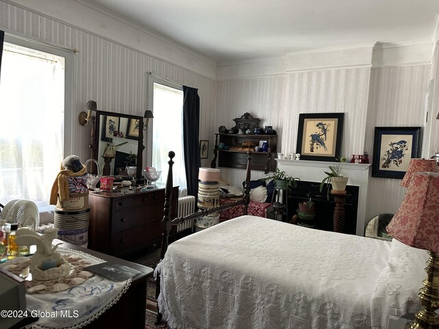 bedroom with crown molding and multiple windows