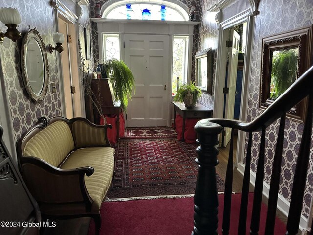 view of carpeted foyer entrance