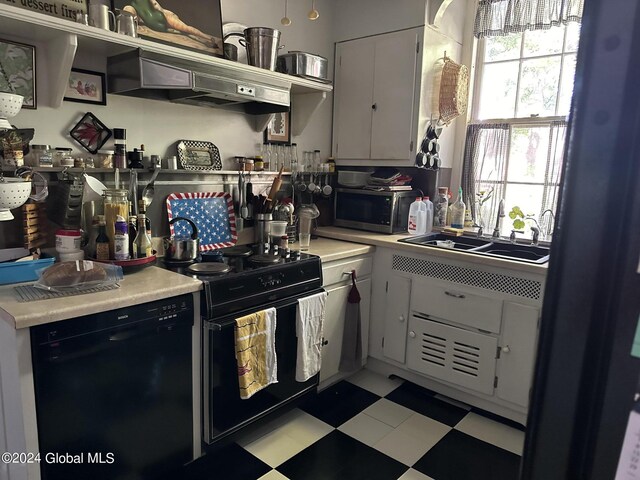 kitchen with black appliances, sink, and white cabinets