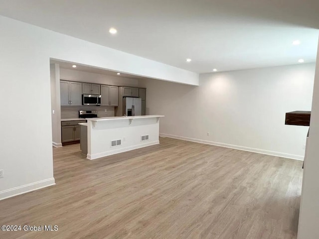 unfurnished living room with light hardwood / wood-style flooring