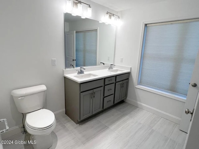 bathroom with vanity, toilet, and walk in shower