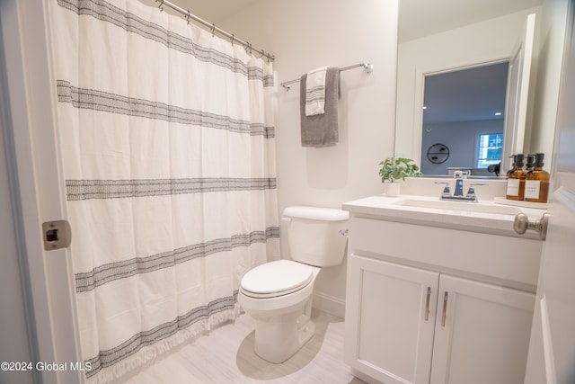 bathroom with vanity, toilet, and a shower with shower curtain