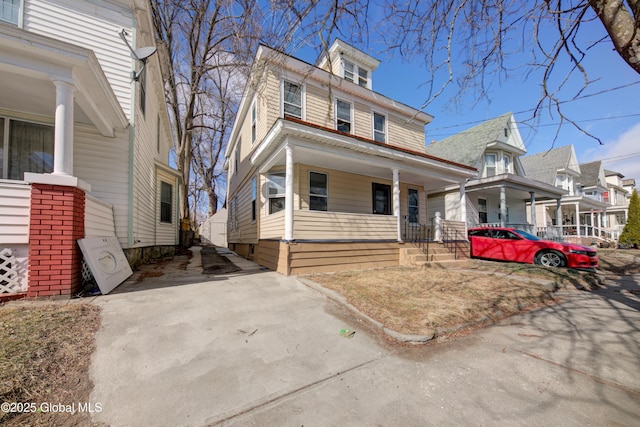 american foursquare style home with a porch