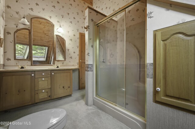 135 Sparrowhawk Lake Rd, Maryland, NY 12155 - full bathroom featuring a stall shower, double vanity, wallpapered walls, and a sink