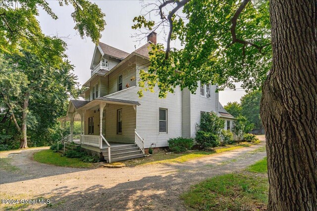 view of side of home with covered porch