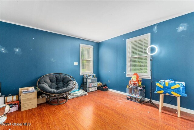 miscellaneous room with hardwood / wood-style flooring and crown molding