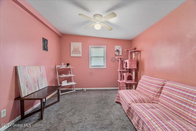 living area with carpet, ceiling fan, and lofted ceiling