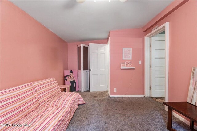 unfurnished bedroom featuring carpet floors, vaulted ceiling, and ceiling fan