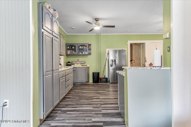 kitchen featuring dark wood-type flooring, crown molding, stainless steel refrigerator with ice dispenser, white fridge, and washer / clothes dryer