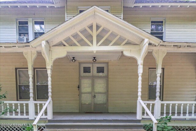 doorway to property with french doors and a porch