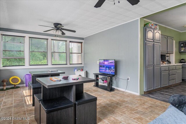 kitchen with gray cabinets, a kitchen island, and ornamental molding