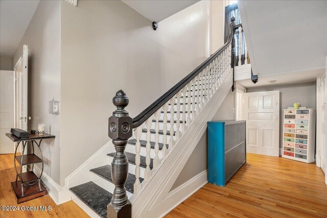 stairway featuring wood-type flooring