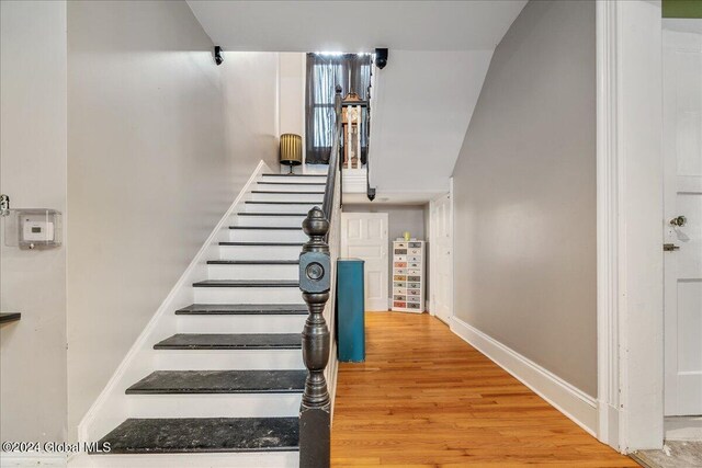 stairway featuring wood-type flooring