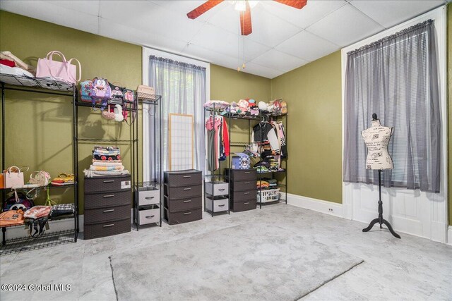 bedroom featuring ceiling fan and concrete flooring