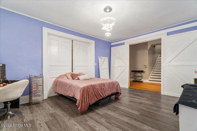 bedroom featuring dark hardwood / wood-style flooring and crown molding