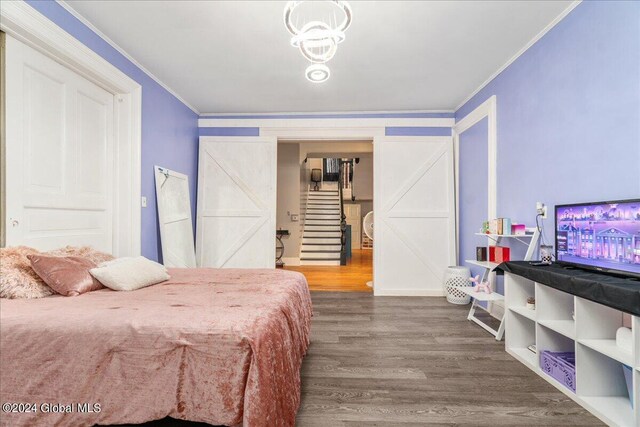 bedroom featuring hardwood / wood-style floors and ornamental molding