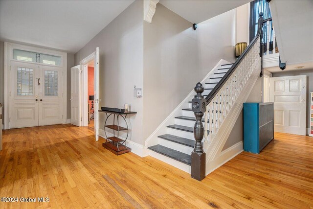 entryway with wood-type flooring and french doors