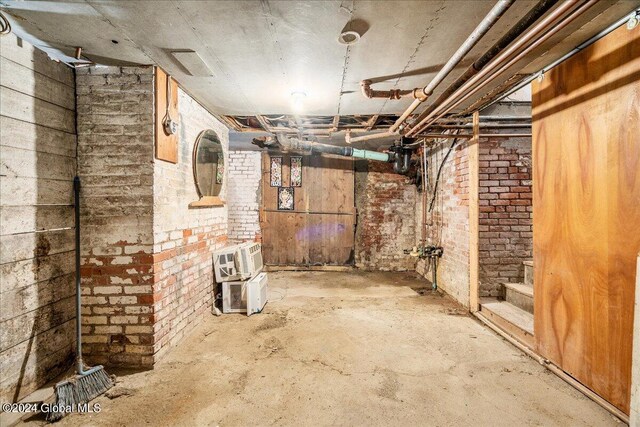 basement with brick wall