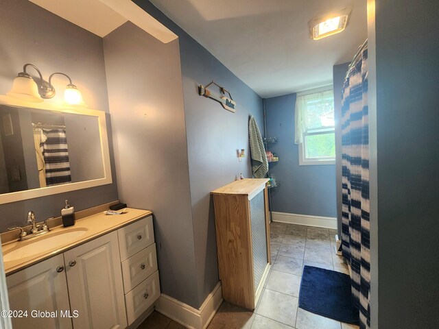 bathroom with tile patterned flooring and vanity