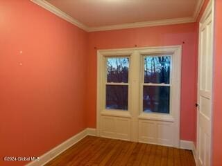 spare room with crown molding and hardwood / wood-style flooring