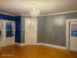 interior space featuring crown molding, hardwood / wood-style floors, and a chandelier