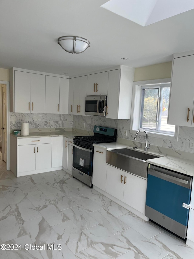 kitchen with appliances with stainless steel finishes, backsplash, and white cabinets