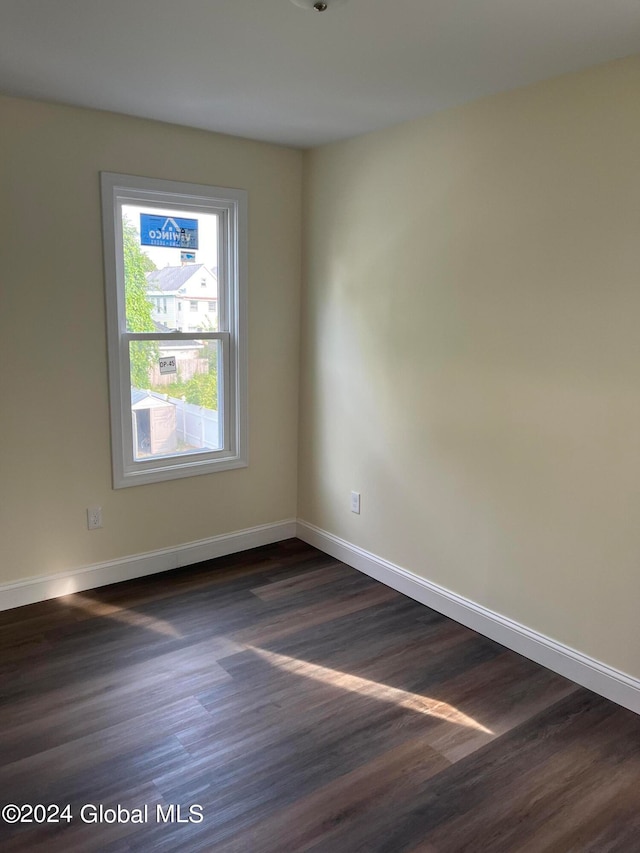 unfurnished room featuring dark wood-type flooring