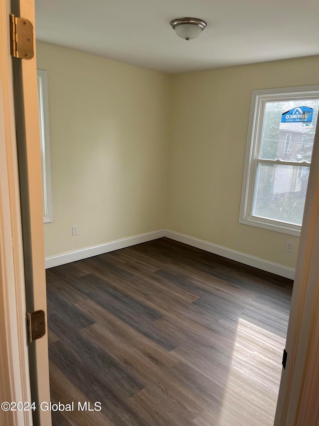 unfurnished room featuring dark hardwood / wood-style floors