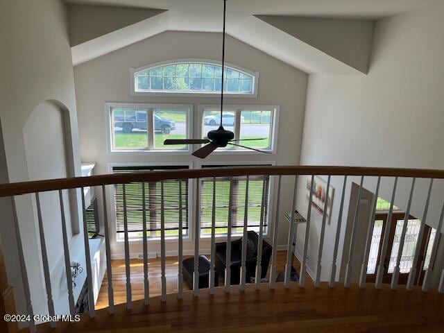 staircase with lofted ceiling, hardwood / wood-style floors, ceiling fan, and a healthy amount of sunlight