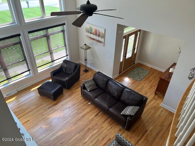 living room featuring ceiling fan, a wealth of natural light, and light hardwood / wood-style floors