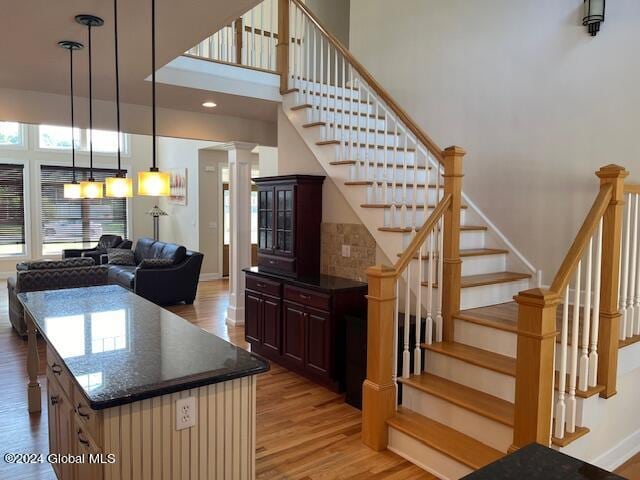 interior space featuring decorative columns and hardwood / wood-style flooring