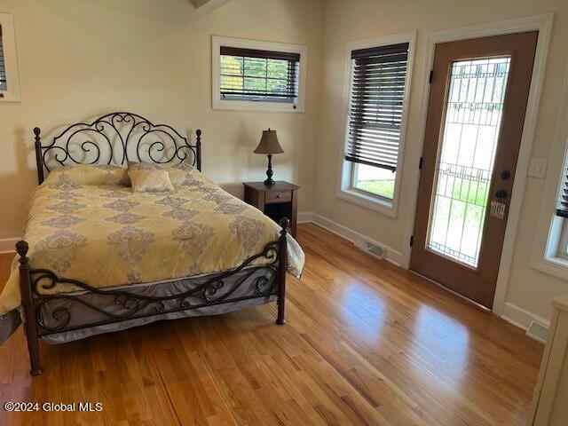 bedroom featuring light wood-type flooring and access to exterior